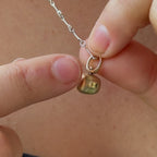 10k spinner pendant with natural green sapphire and recycled brown diamond handmade by em jono 