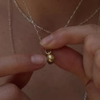 handmade two sided 10k gold spinner pendant with a natural blue sapphire and recycled diamond strung on .925 bar chain by em jono 